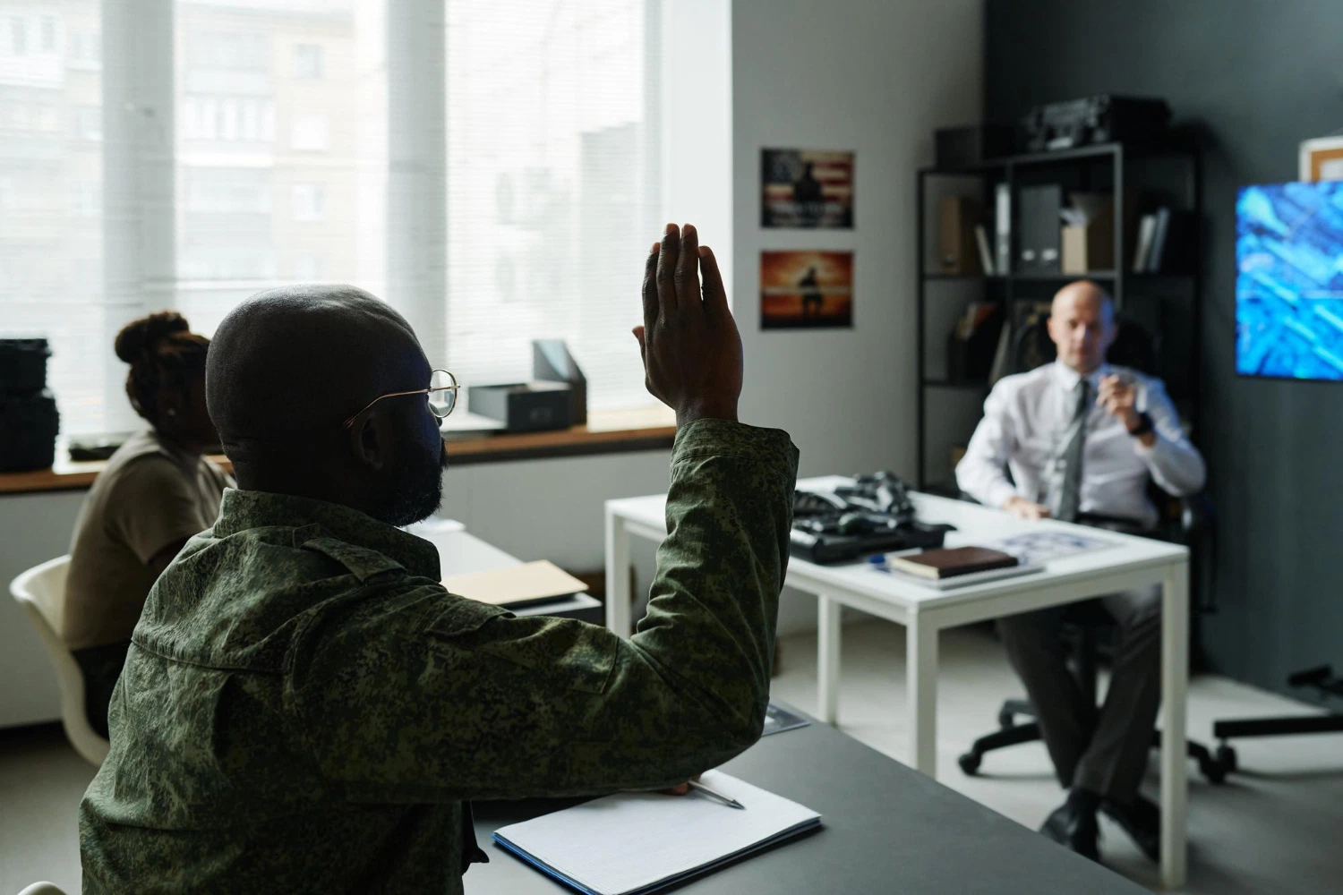 Cadet raising a hand during a class at one of the six senior military colleges
