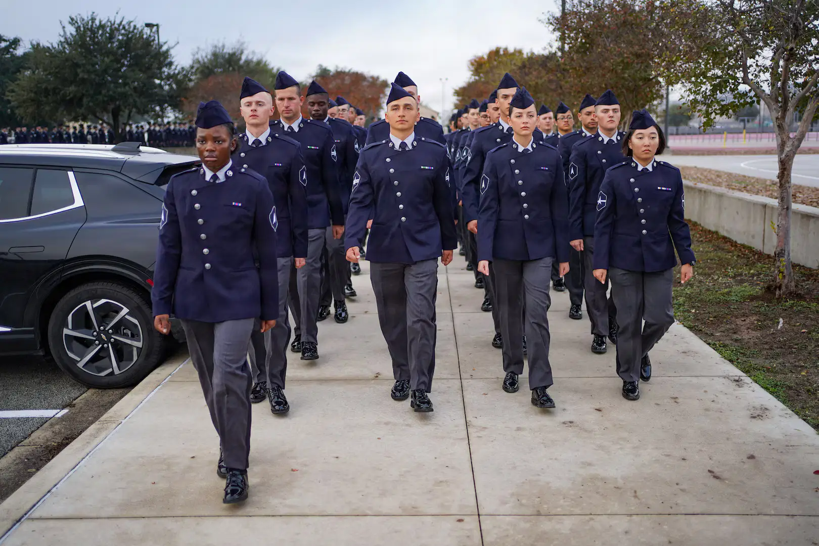 Space Force recruits in blue uniforms marching at JBSA-Lackland basic training