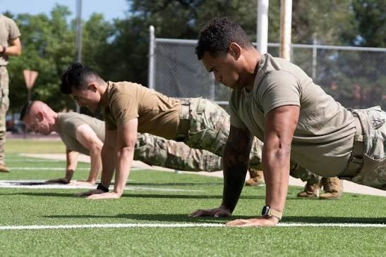 Instructor watching recruits do push-ups during Space Force basic training