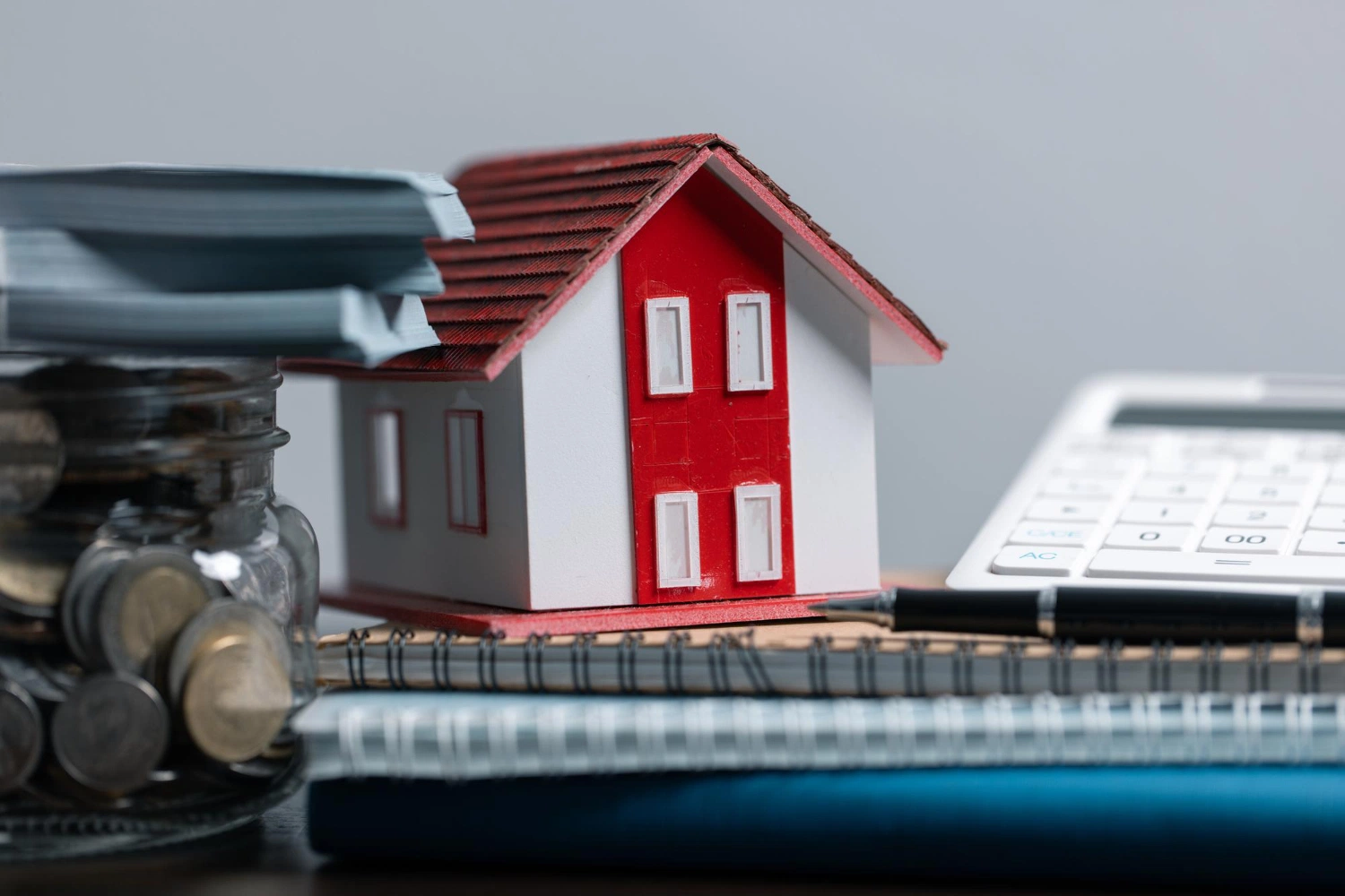 House model beside a calculator, representing 2026 BAH rate calculations