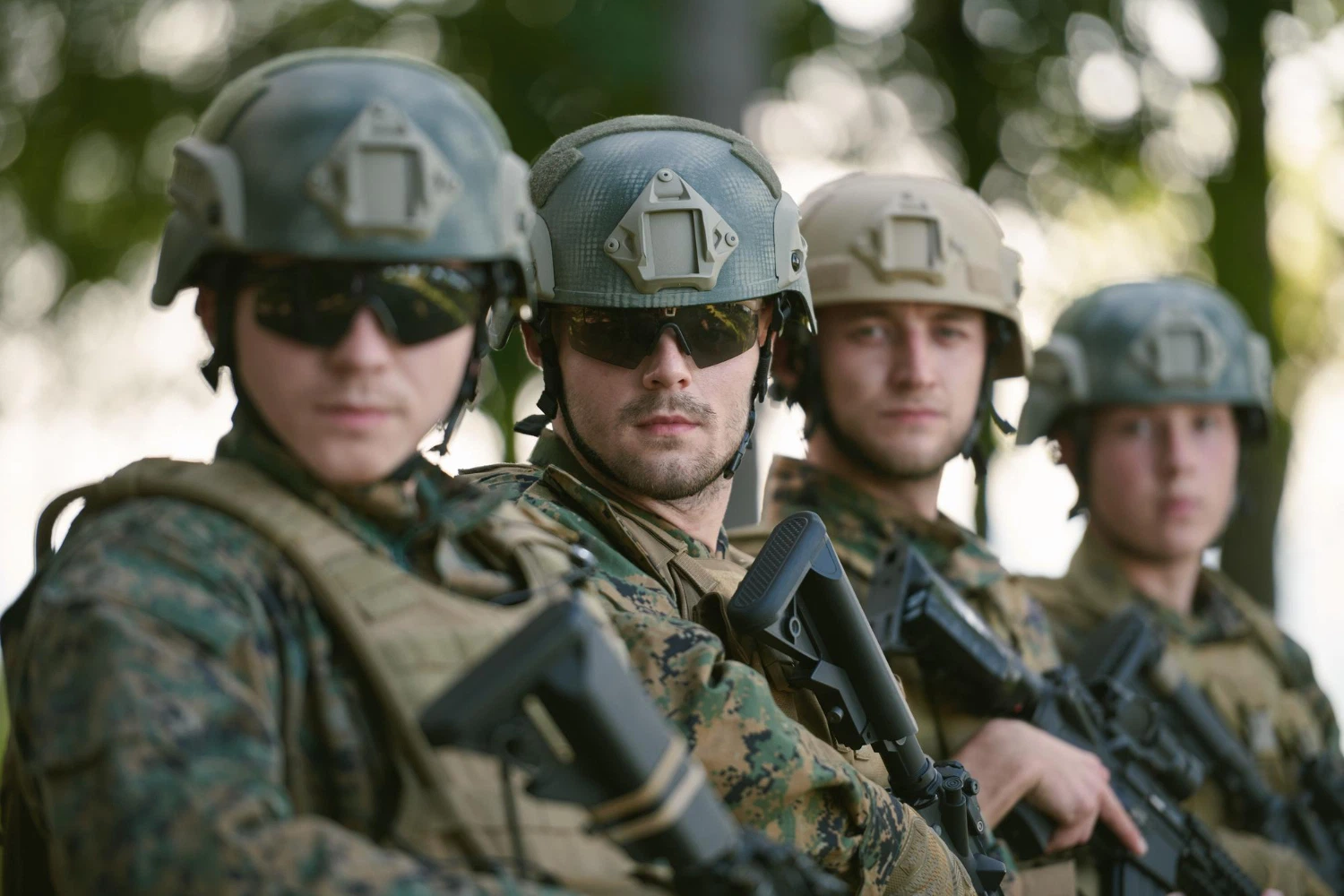 Four Guardians in helmets and camouflage, showing how rank fits the uniform