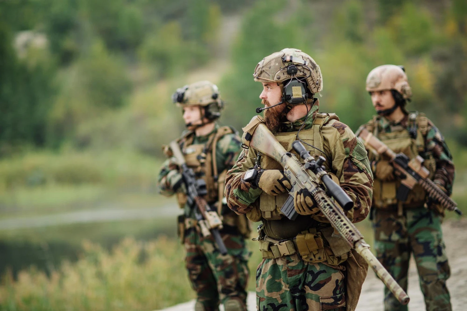 Guardians carrying rifles in the field, illustrating pay that rises with rank