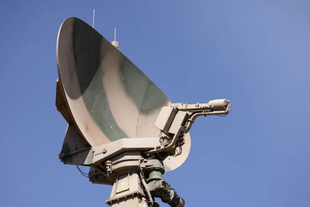 Large radar antenna dish against a clear blue sky