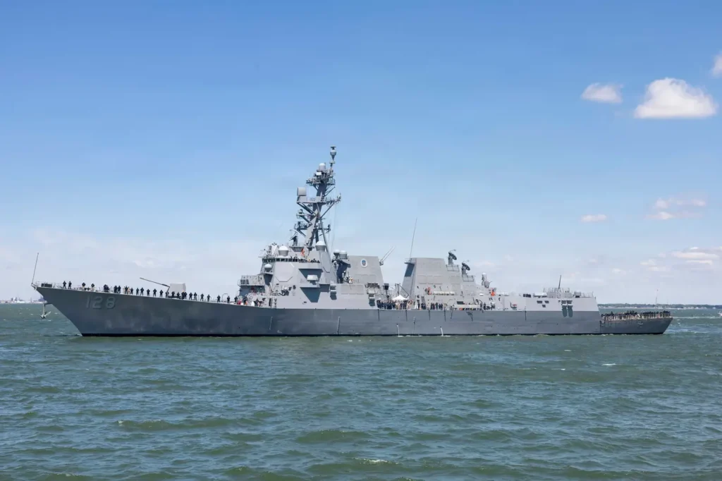 US Navy sailors man the rails as the destroyer USS Ted Stevens (DDG 128) arrives in Norfolk