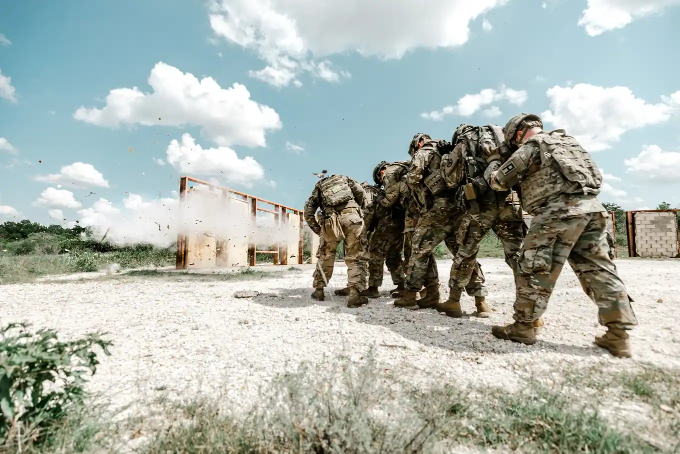 Soldiers in camouflage lined up during a field training exercise