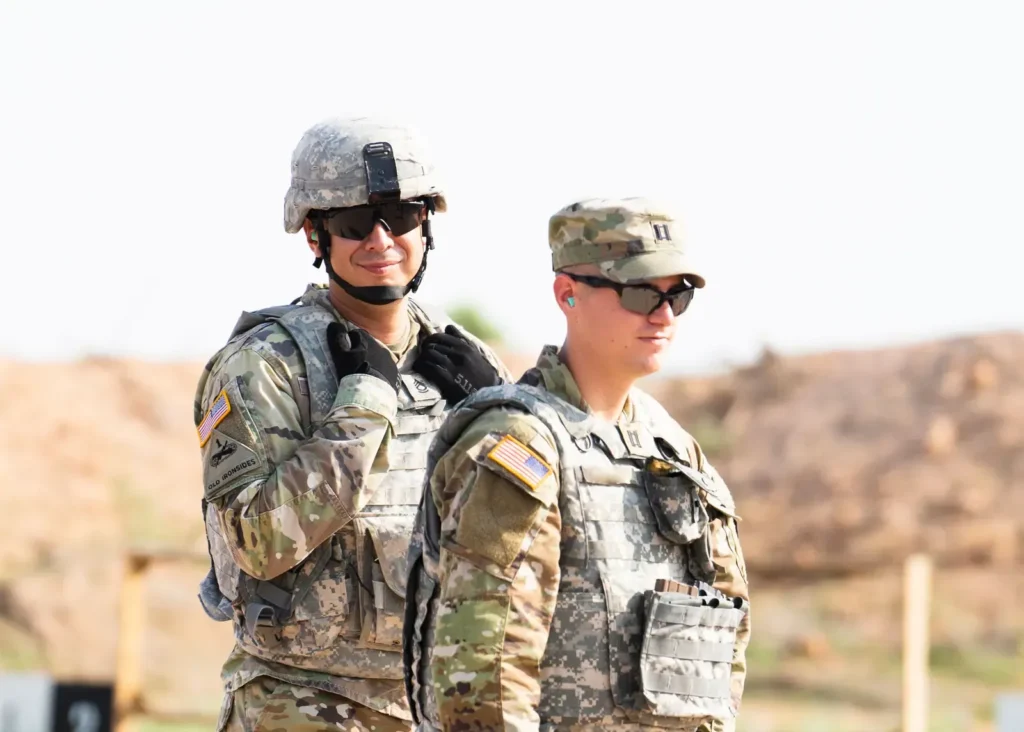 Two U.S. Army soldiers in helmets and body armor at a training range