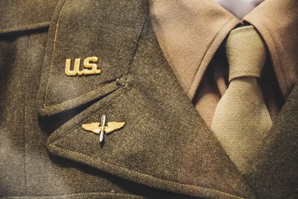 Gold U.S. collar insignia and aviator wings on a service uniform lapel